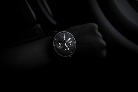 A sleek Moto 360 smartwatch showing time on a wrist in a dimly lit setting, emphasizing its modern design and technology.